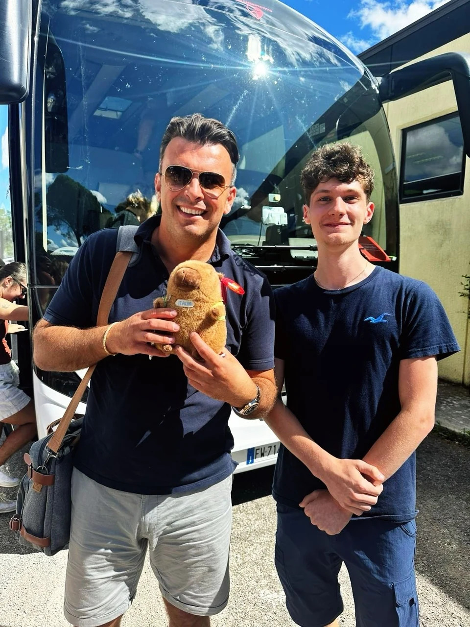 Sasha Rojnik with a guest beside a tour coach